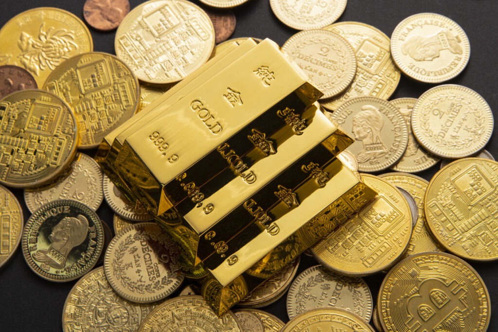 Home closeup shot of a pile of shiny gold coins and bars